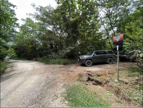 a truck parked on the side of a dirt road at Sweet Jungle in Quesada