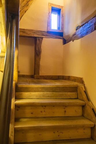 a set of stairs in a room with a window at Boutique-Hotel Stadtherberge Wetzlar in Wetzlar