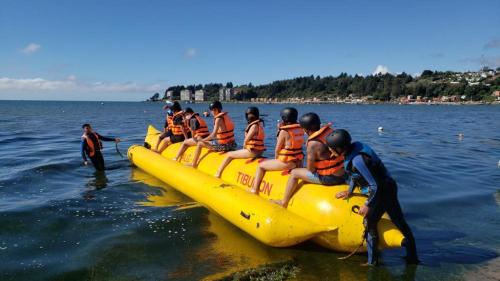 a group of people on a raft in the water at Dichato full vista al mar in Tomé