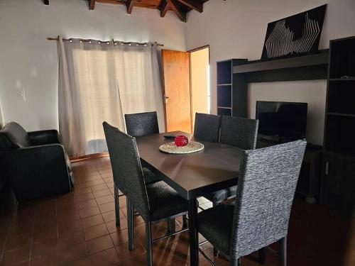 a dining room table with chairs and a bowl on it at Complejo Cerrado Zona Shopping in Guaymallen