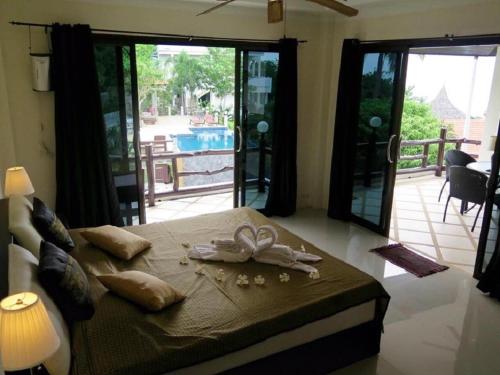 a bedroom with a bed with a bow on it at Viking House Villa Deluxe in Koh Tao
