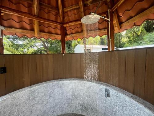 a large bath tub with a shower and a window at Sweet Jungle in Quesada