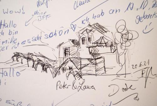 a drawing of a house on a wall with signatures at Boutique-Hotel Stadtherberge Wetzlar in Wetzlar