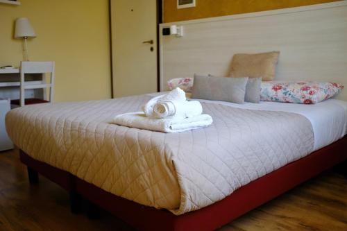 a bedroom with a bed with towels on it at Mi Casa Affittacamere in Osio Sotto