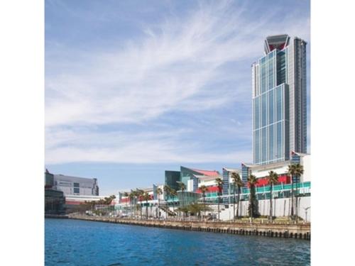 a large building next to a body of water at Sakishima Cosmo Tower Hotel - Vacation STAY 01082v in Osaka