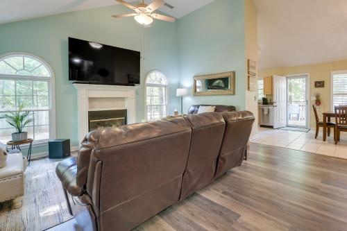 a leather couch in a living room with a fireplace at Pet-Friendly LaGrange Vacation Rental with Deck! in La Grange