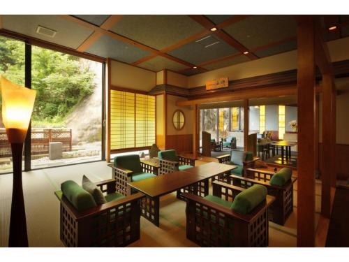 a restaurant with tables and chairs and a large window at Kinugawa Onsen Yusuikiko Hotel Otaki - Vacation STAY 68843v in Nikko