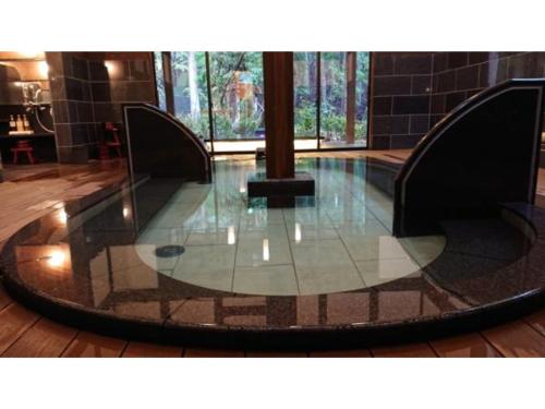 a glass floor in a building with a large window at Kinugawa Onsen Yusuikiko Hotel Otaki - Vacation STAY 68843v in Nikko