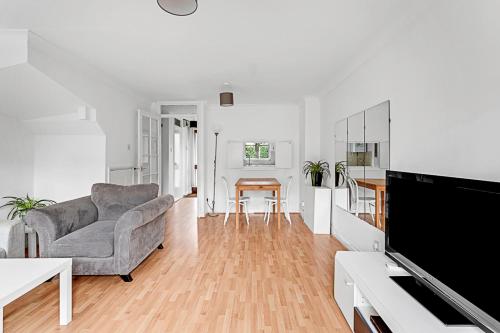 a living room with a couch and a table at Beautiful Richmond House in Richmond upon Thames