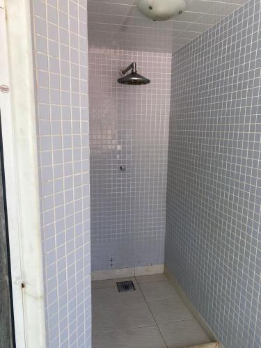 a bathroom with a shower with blue tiles at Apartamento com Vista Imperdível in Rio de Janeiro