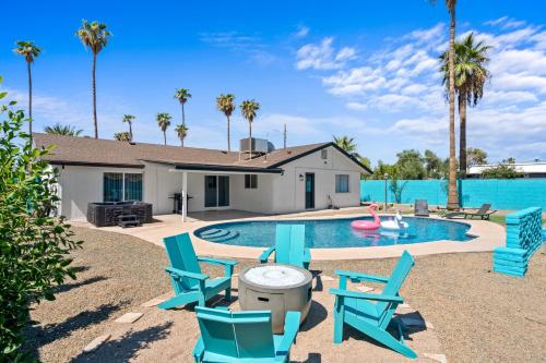 a swimming pool with blue chairs and a house at Tempe STR/MTR-close to ASU, Old Town & PHX airport in Tempe