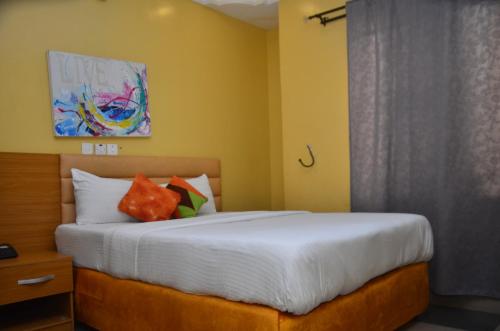 a bedroom with a bed and a window at Hollandas Hotel in Ijebu Ode
