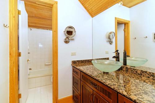 a bathroom with two sinks and a shower at Independence Square 210, Beautiful Studio with Kitchenette, Great Location in Downtown Aspen in Aspen