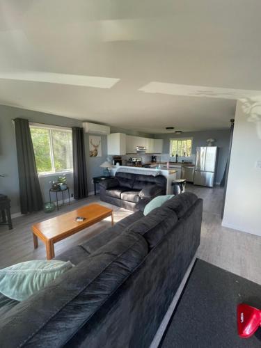 a living room with a couch and a table at Sunrise Mountain view Skidegate House 