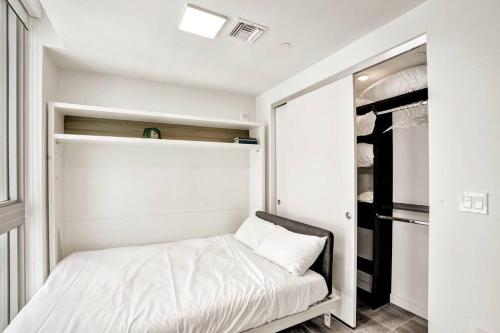 a small bedroom with a bed and a closet at Miami Skylight View 2008 in Miami