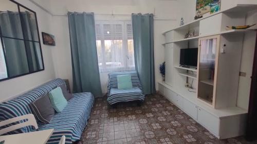 a living room with a couch and a tv at BREZZA SUL MARE in Fiumaretta di Ameglia