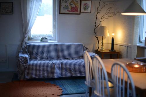 a living room with a couch and a table at Odpocznij in Dąbrówka