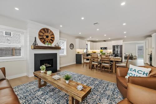 a living room with a couch and a fireplace at Renovated & Sophisticated Home Near Beach & Shops! in Barnstable