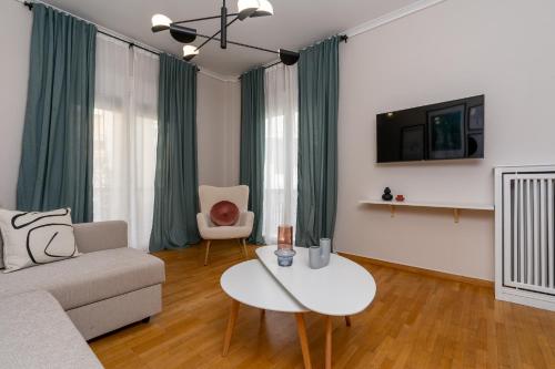 a living room with a couch and a table at Athenian Classy 2BD Apt next to Metro Panepistimio in Athens