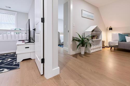 a white room with a bedroom and a living room at Renovated & Sophisticated Home Near Beach & Shops! in Barnstable