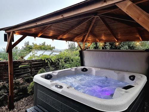 a bath tub sitting under a gazebo at Stag Manor Hot Tub Retreat near Peak District in Crich