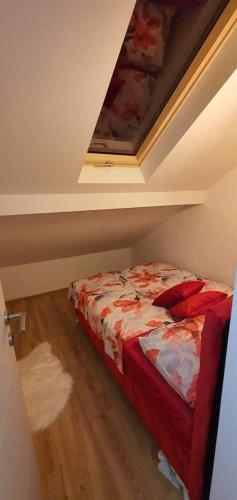 a bedroom with a bed in a room with a ceiling at Vikendica OM relax in Prijedor