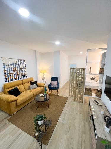 a living room with a couch and a chair at Venerable 15A in Córdoba