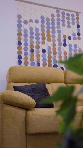 a couch with a pillow on it with a wall at Venerable 15A in Córdoba