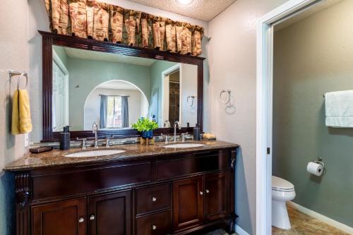 a bathroom with two sinks and a large mirror at Eternity's Edge - Hike to JTNP, Private, Modern in Twentynine Palms