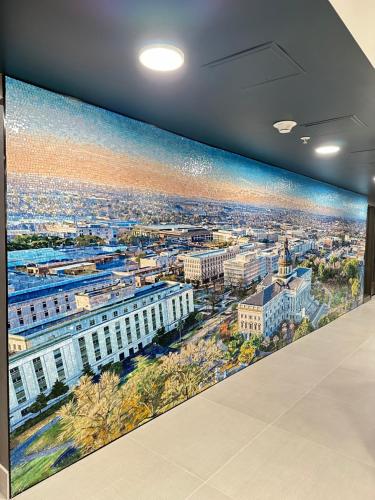 a large painting of a city on a wall at La Quinta Inn by Wyndham Columbia NE Fort Jackson in Columbia