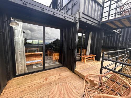 a screened in porch with two chairs and a table at Nomada Republic Hotel El valle in Valle de Anton