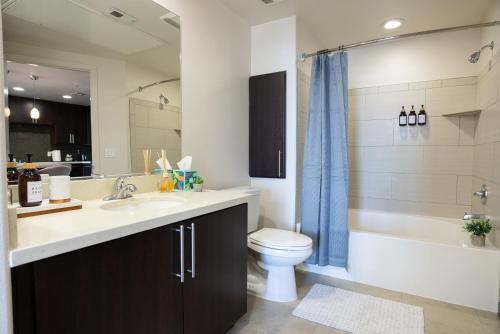 a bathroom with a sink and a toilet and a shower at Luxury Apartment West Hollywood in Los Angeles