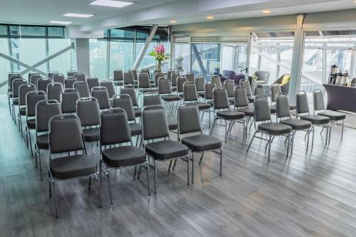 a room with rows of chairs in a building at GHL Collection 93 in Bogotá