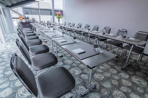 a row of tables and chairs in a room at GHL Collection 93 in Bogotá