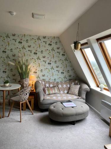 a living room with a couch and a table at Serendipity ~ Romantic Hideaway in Ambleside in Ambleside