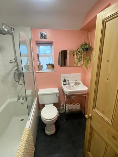 a bathroom with a toilet and a sink and a shower at Cardiff - Home from Home in Cardiff