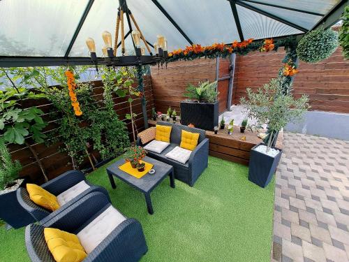 a patio with couches and a table and plants at "Oasis of Peace Zagreb-Apartments" in Zagreb