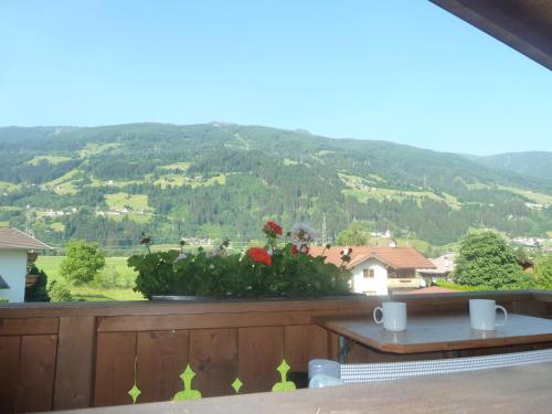 a balcony with a table and a view of a mountain at Apart Franz Josef in Stumm