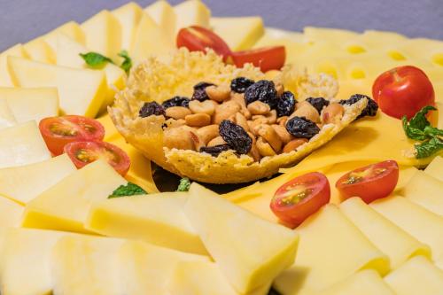 a plate of food with cheese and tomatoes on it at GHL Collection 93 in Bogotá
