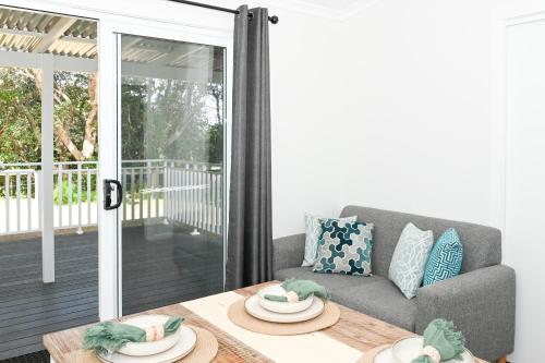 a living room with a couch and a table at NRMA Toowoon Bay Holiday Park in The Entrance