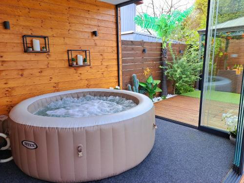a hot tub in the middle of a patio at "Oasis of Peace Zagreb-Apartments" in Zagreb