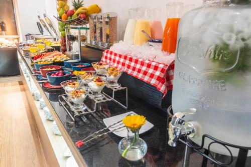 a buffet line with glasses of food on it at GHL Collection 93 in Bogotá