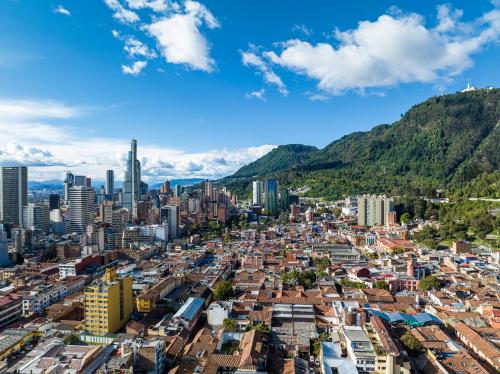 an aerial view of a city with mountains in the background at GHL Collection 93 in Bogotá