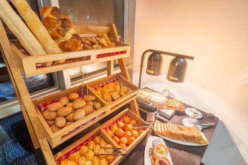a table with several boxes of bread and pastries at GHL Collection 93 in Bogotá