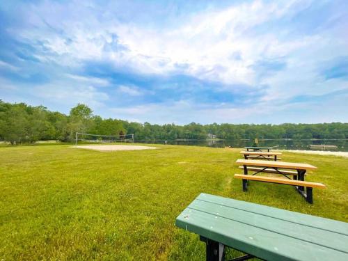two picnic tables in a field with a goal at Zen Spa Oasis Retreat Sauna/Hotub/Firepit/Fun/Gameroom in Blakeslee