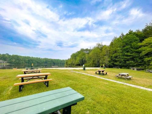 a group of picnic tables in a field at Zen Spa Oasis Retreat Sauna/Hotub/Firepit/Fun/Gameroom in Blakeslee