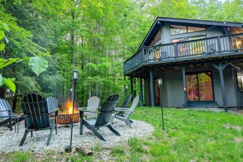 a group of chairs sitting around a fire in front of a house at Zen Spa Oasis Retreat Sauna/Hotub/Firepit/Fun/Gameroom in Blakeslee