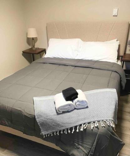 a bed with two towels and two pillows on it at Zen Spa Oasis Retreat Sauna/Hotub/Firepit/Fun/Gameroom in Blakeslee