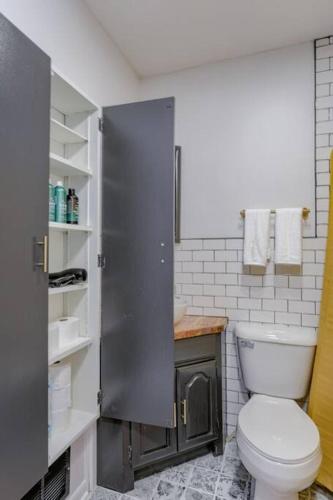a bathroom with a toilet and a shower in it at Beautiful - 4bd with Contemporary Interior in Lincoln
