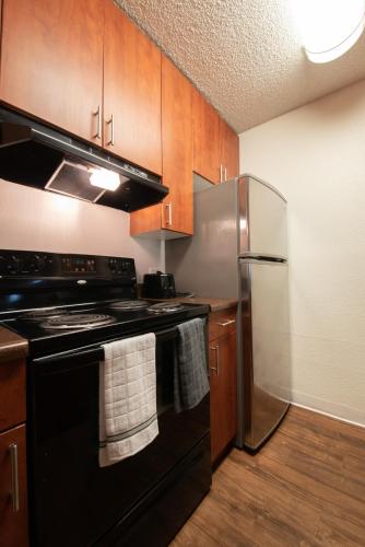 a kitchen with a black stove and a refrigerator at Luxurious stay near the beach in Newport Beach